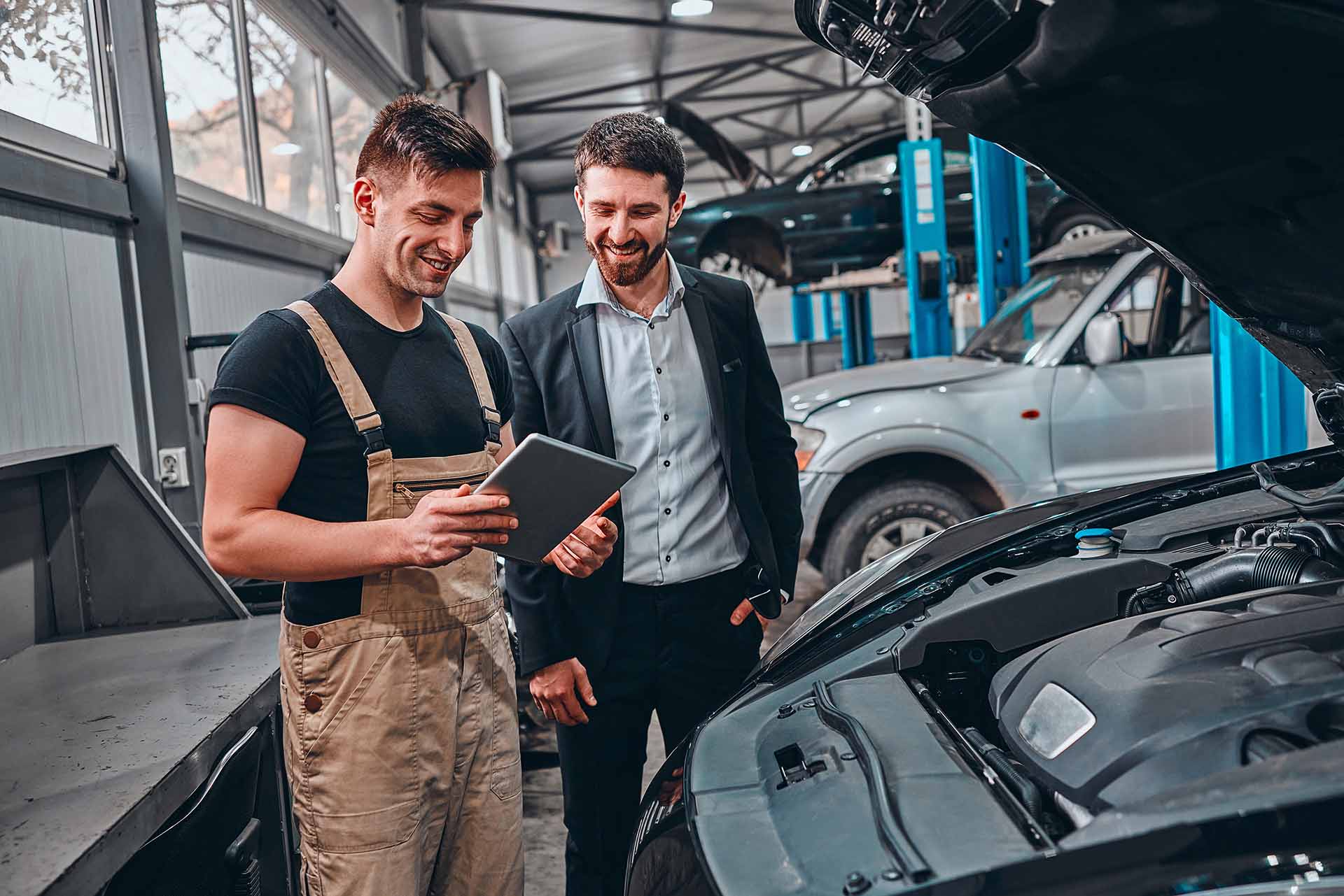 Customer listening to his mechanic at the repair garage. Selective focus.